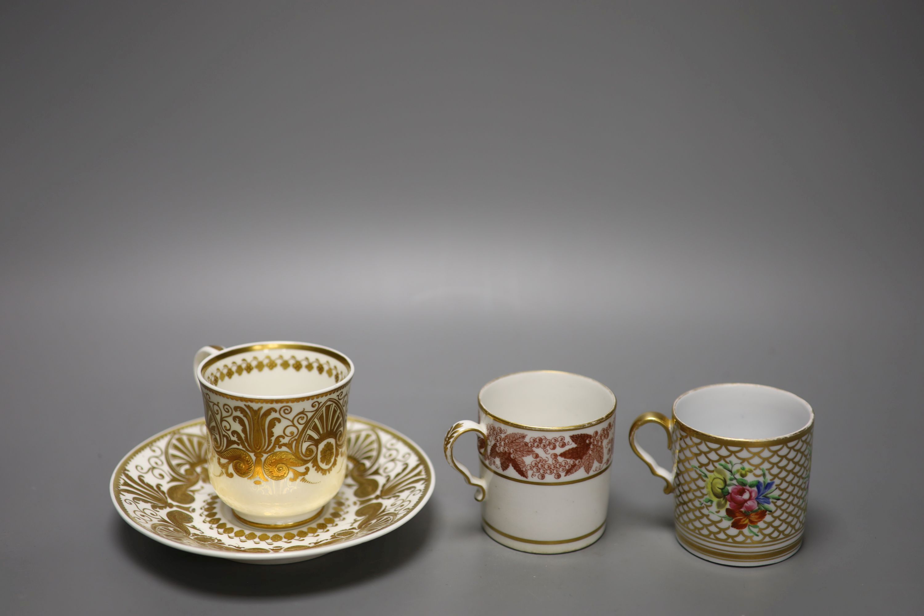 A Spode fine cup and saucer decorated with raised gilding in neo-classical style pattern Spode 4327 in red,